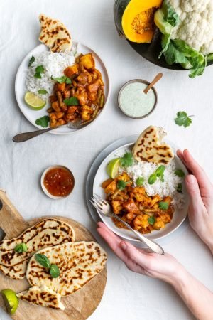 Vegetarian, vegan Indian Balti curry, female hands holding one plat